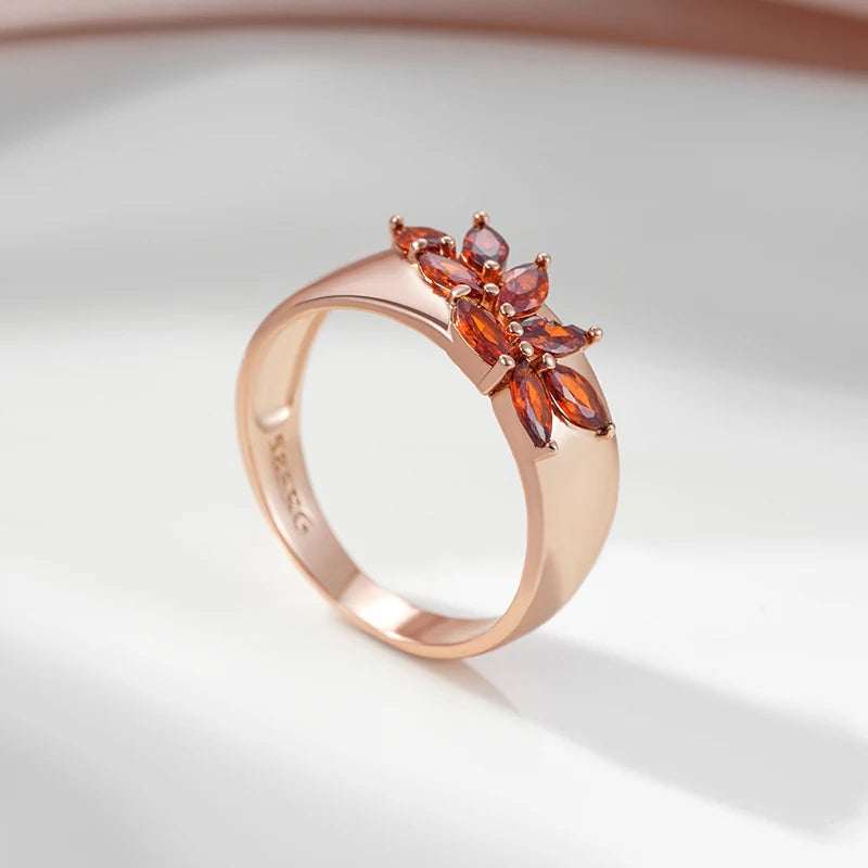Rose gold leaf ring with red zircon worn on finger