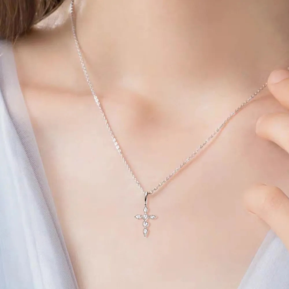 Model wearing 925 sterling silver moissanite cross pendant necklace.