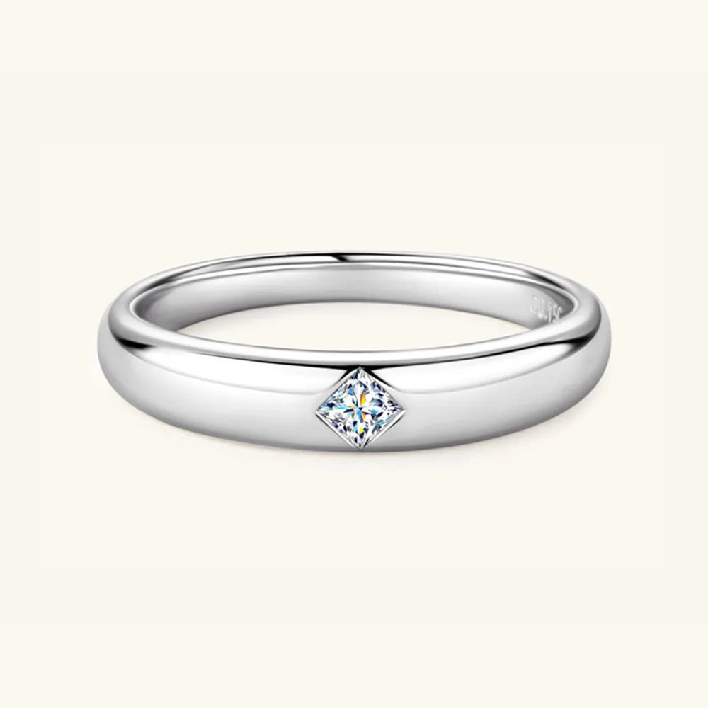 Polished silver ring with flush-set princess cut D-color moissanite gem.