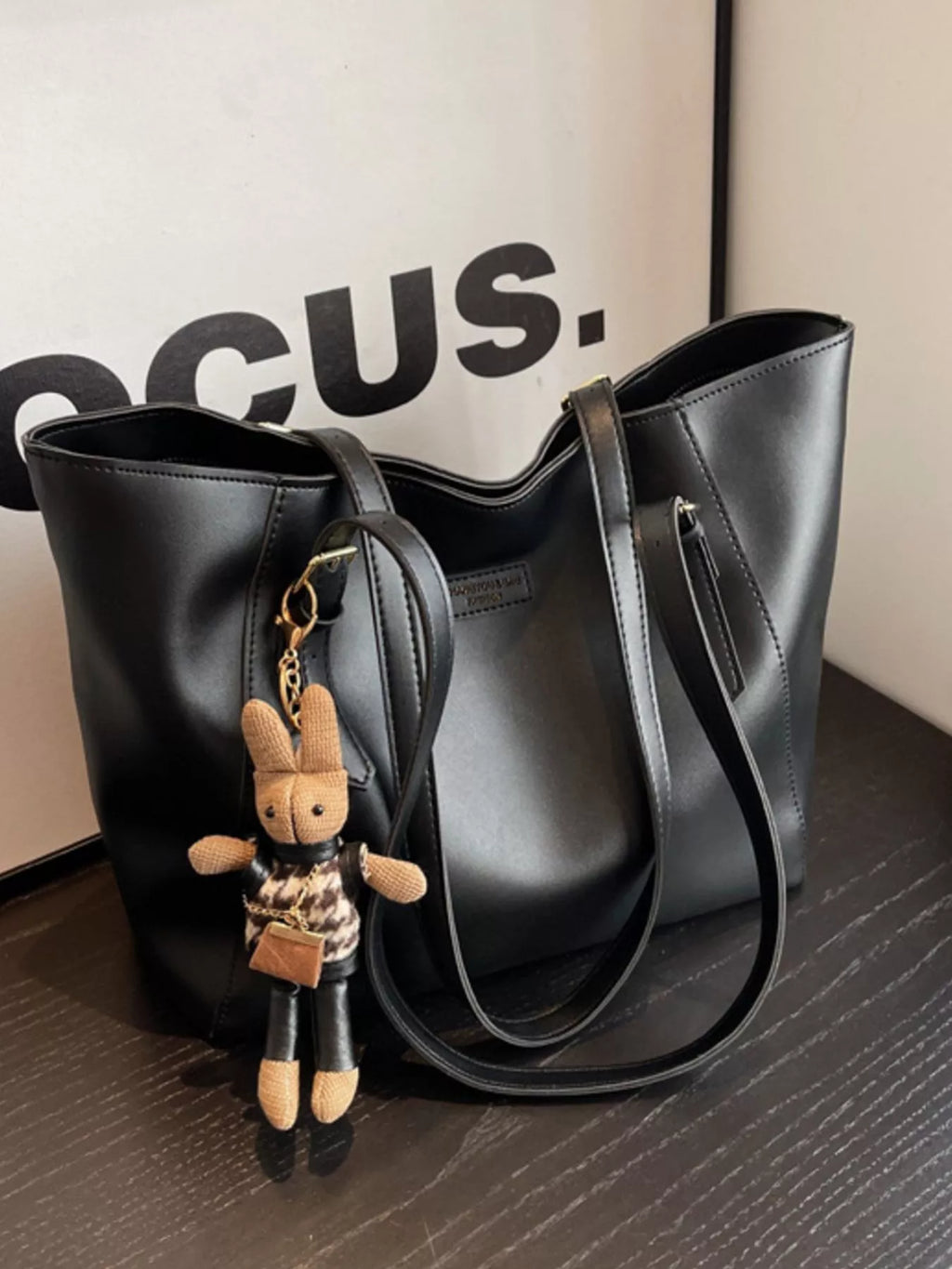 Slouchy black vegan leather tote bag - front view showing relaxed silhouette