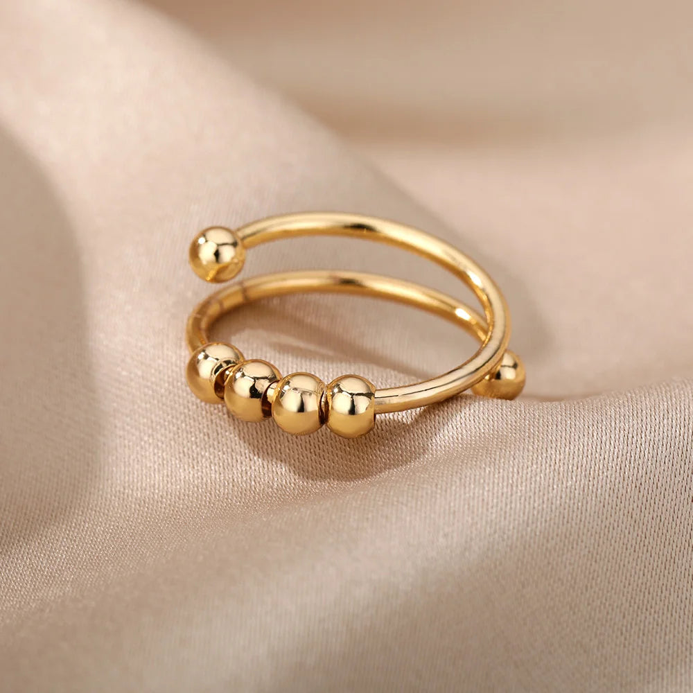 Silver-tone spinner ring side profile showing open adjustable band