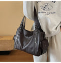 Vertical-Zip Vegan Leather Multi-Compartment Tote in coffee brown, studio product shot showing structured silhouette and buckle strap detail – Varex HQ