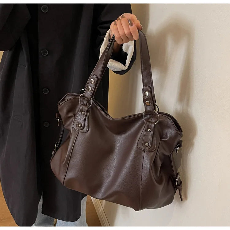 Vertical-Zip Vegan Leather Multi-Compartment Tote in coffee brown, held by hand showing handle detail and structured silhouette – Varex HQ