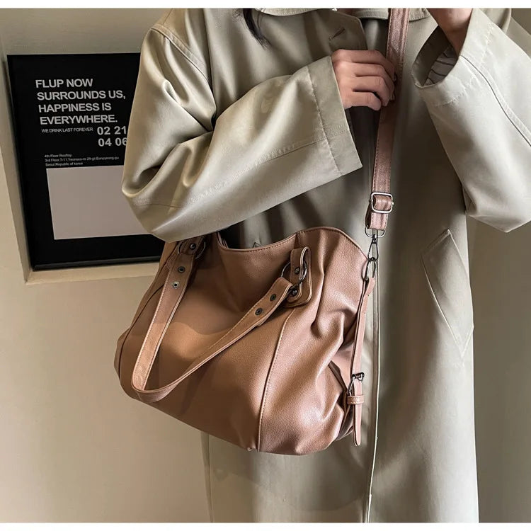 Vertical-Zip Vegan Leather Multi-Compartment Tote in light tan, worn over shoulder with crossbody strap showing structured silhouette – Varex HQ