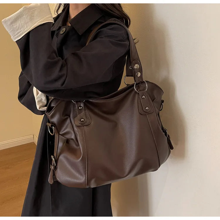 Vertical-Zip Vegan Leather Multi-Compartment Tote in coffee brown, worn over shoulder showing buckle strap and structured silhouette – Varex HQ