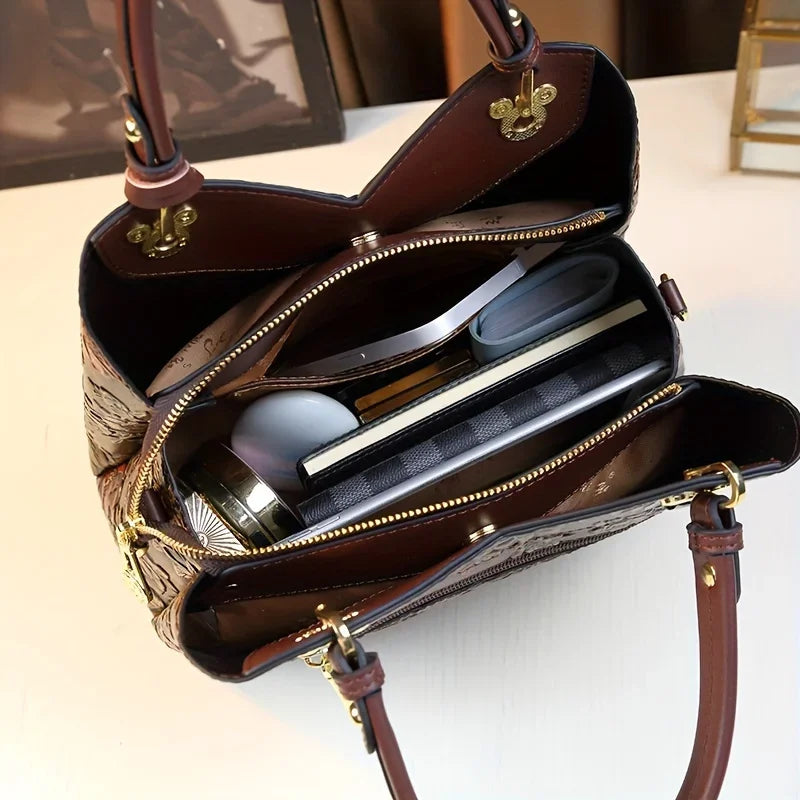 Brown floral vegan leather tote bag - side angle showing zip-top closure and embossed texture