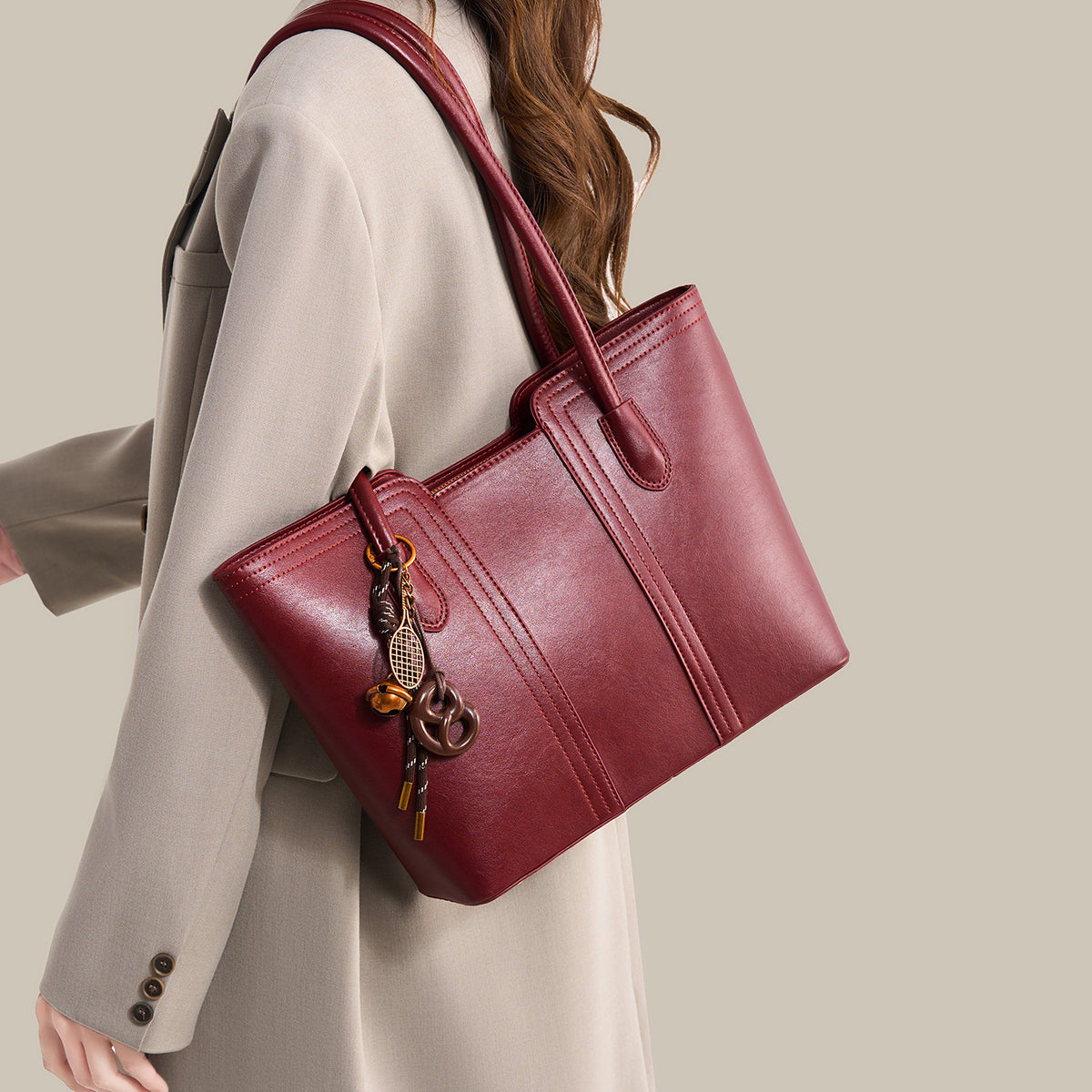 Wine red vegan leather tote bag - front view showing structured silhouette and gold-tone hardware