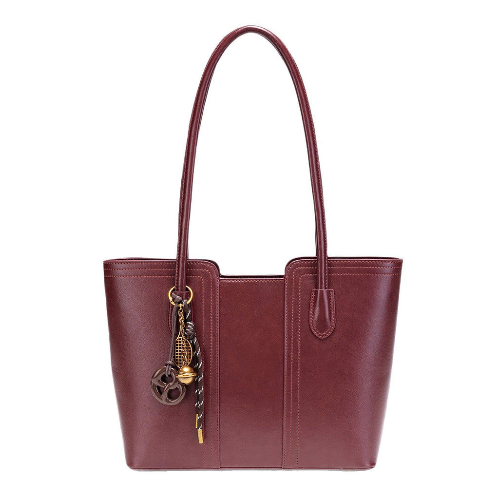 Wine red vegan leather tote bag - lifestyle shot worn on the shoulder