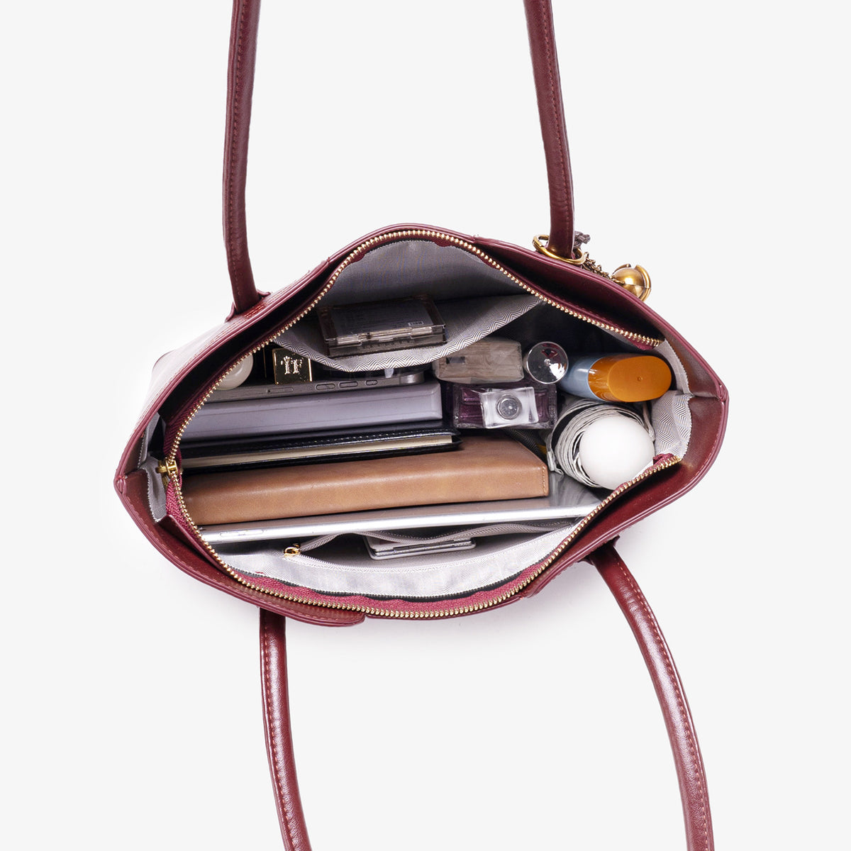 Wine red vegan leather tote bag - side angle showing zip-top closure and vegan leather texture