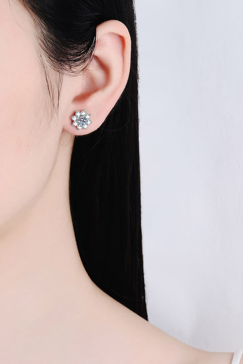 Woman wearing 925 sterling silver moissanite flower stud earring close-up shot.
