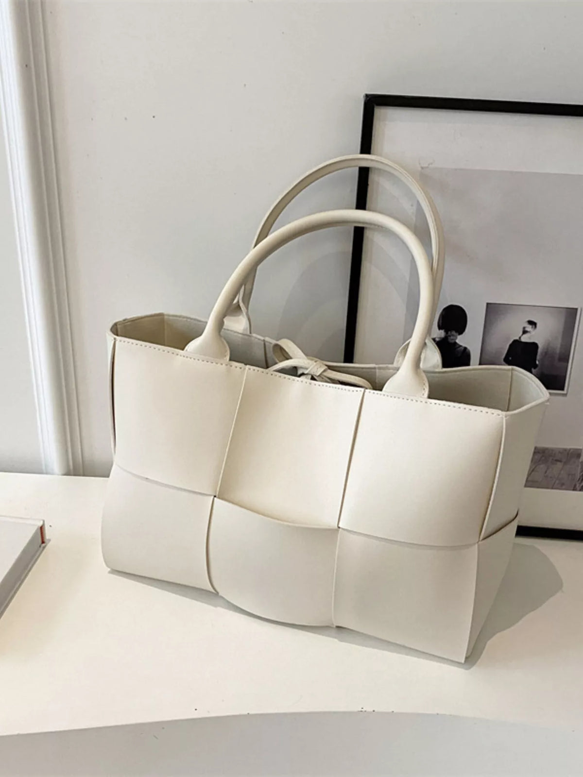 Woven tan vegan leather tote bag - lifestyle shot carried by hand